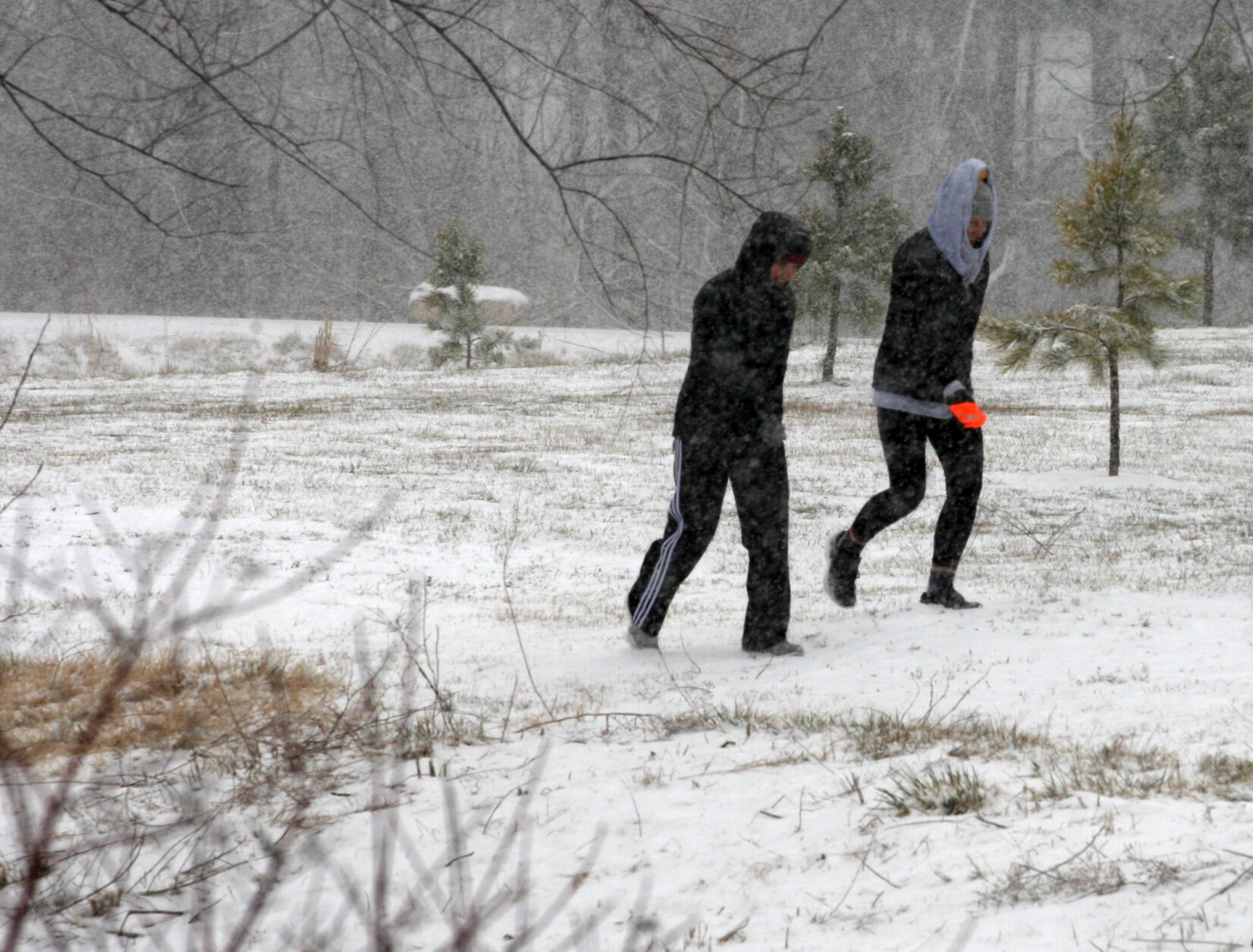 Rachael Leslie and Melissa Shust walk through the park